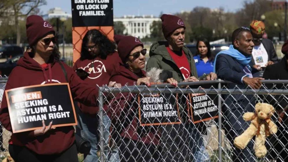 US halts asylum decisions as troop killing sparks migrant crackdown