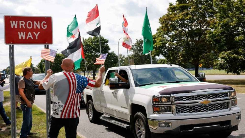US-Palestinian Man Hoists Flag Amid Settler Siege of West Bank Home