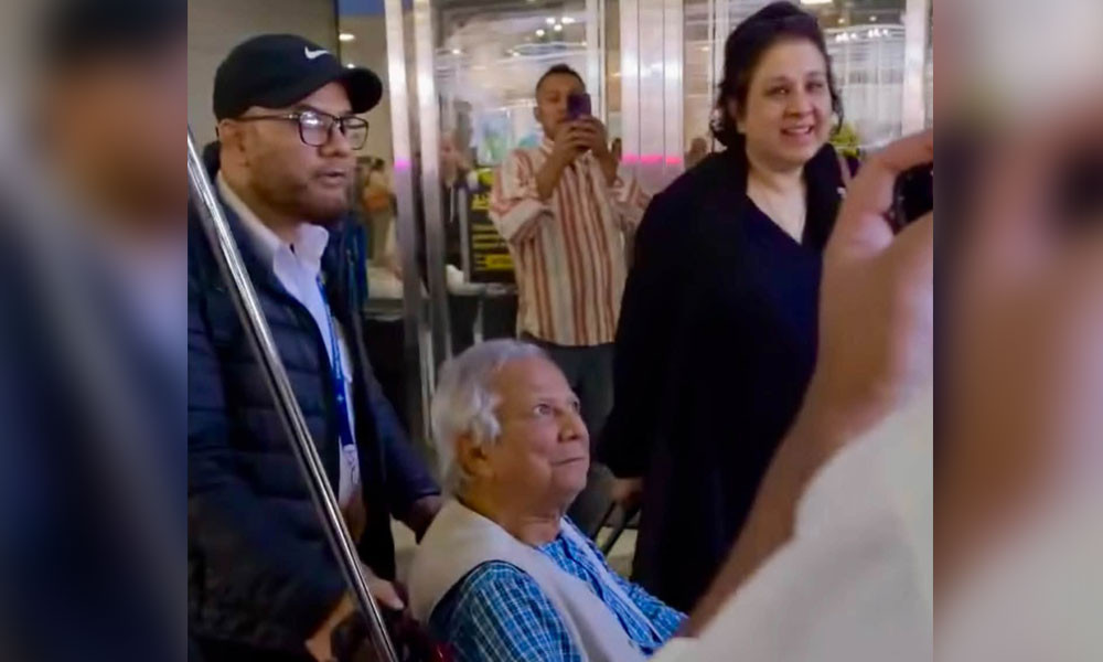 Dr. Yunus faces a barrage of questions at New York airport.