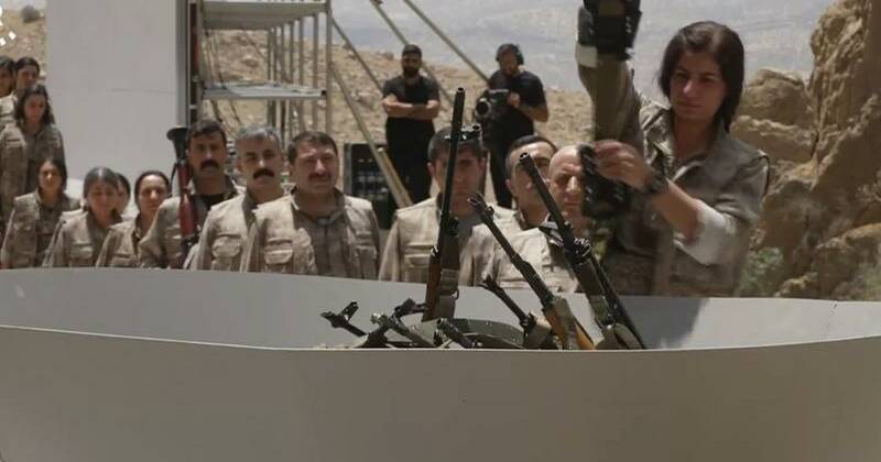 Kurdish PKK militants burn weapons in Iraq to launch disarmament